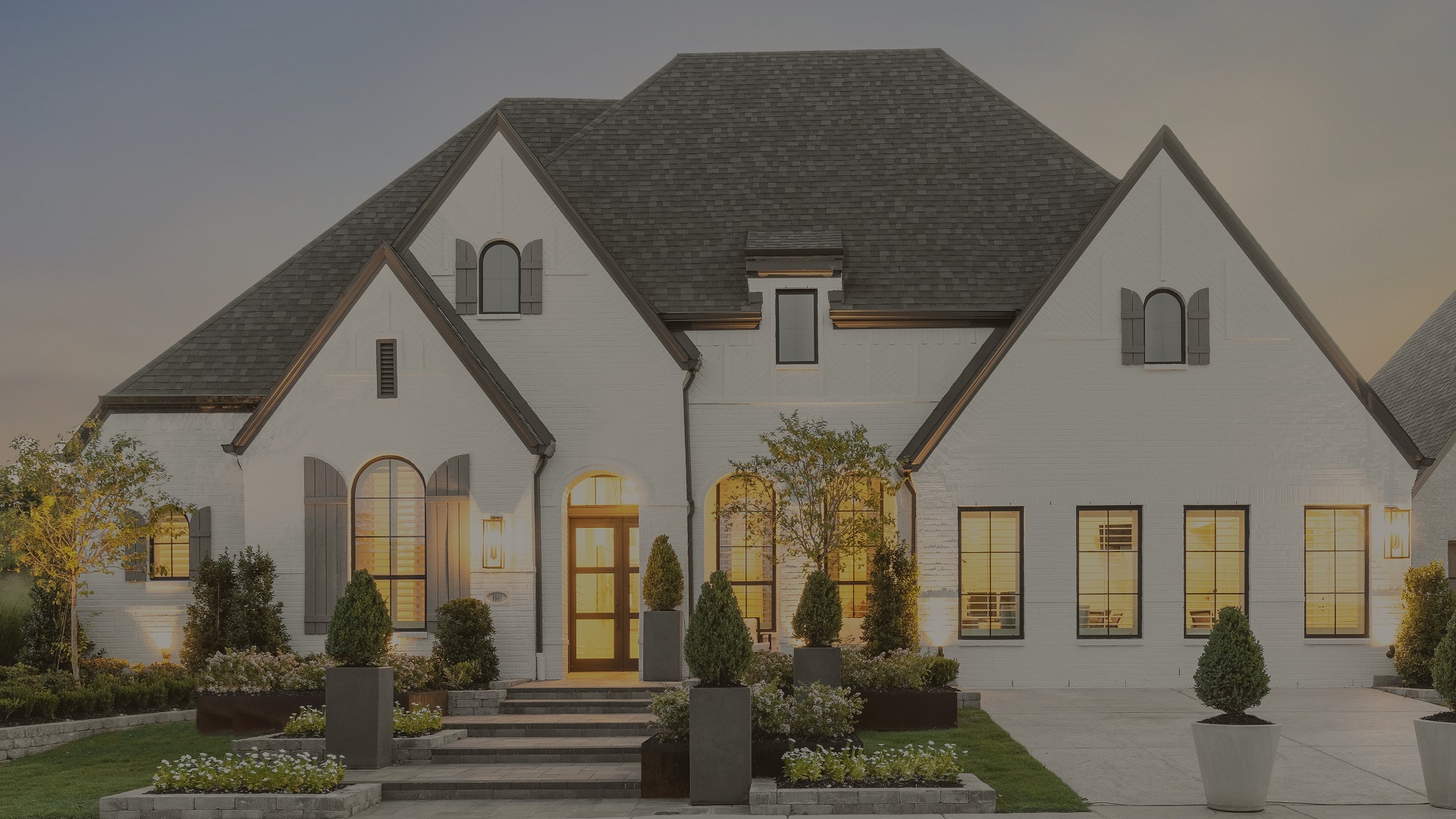 Highland Homes luxury model home at Mirabella in Prosper, TX with stone-and-brick facade and manicured landscaping