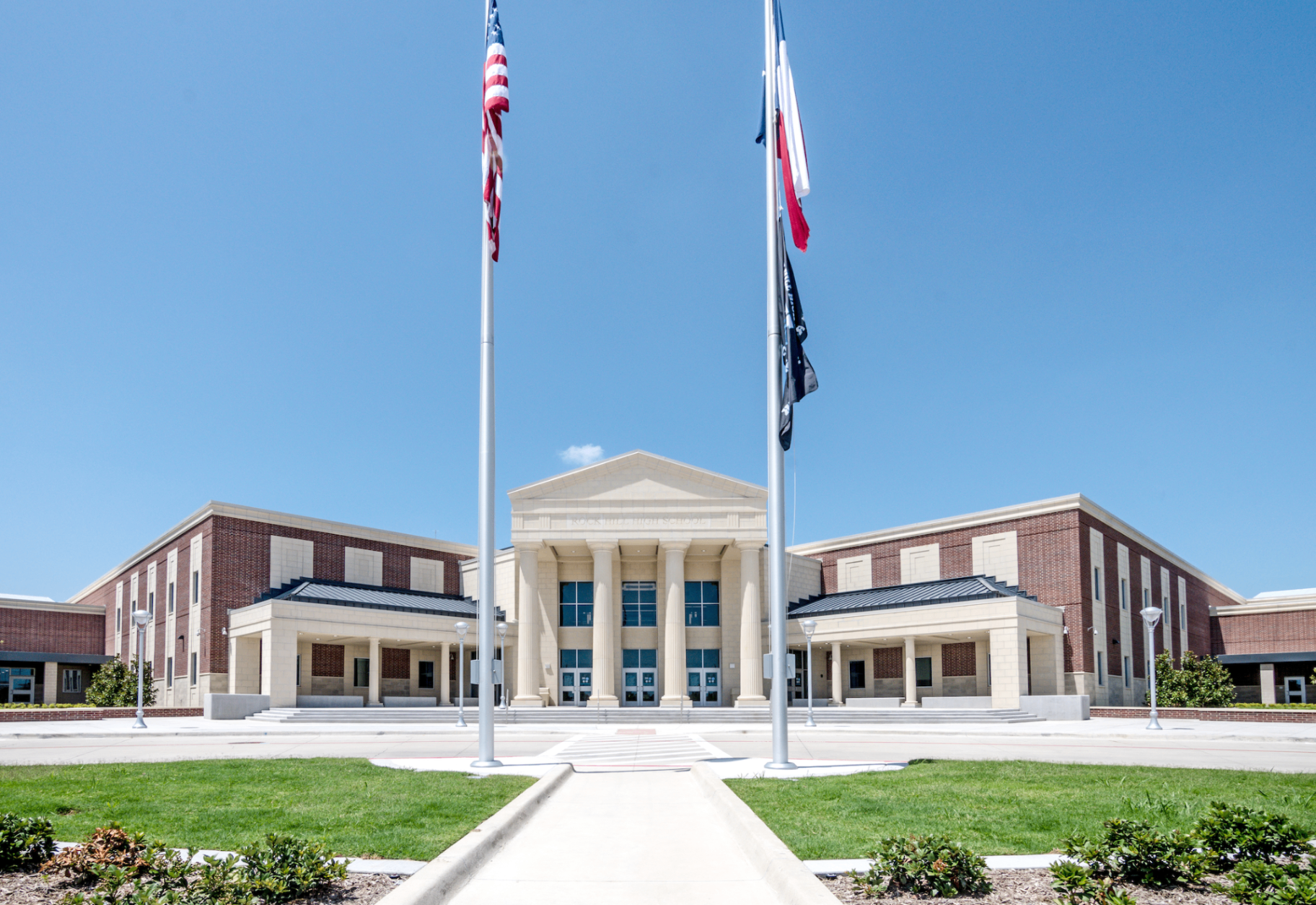 Rock Hill High School entrance with American and Texas flags in Prosper ISD